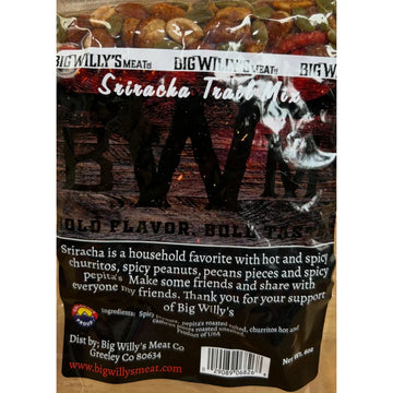 Packaged snack mix with visible branding on a wooden surface. Spicy Nut Snack Mix, Gourmet Spicy Snacks, Spicy Pepitas and Peanuts